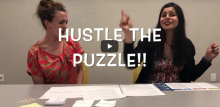 Snapshot from a recorded video that says "Hustle the Puzzle!!"